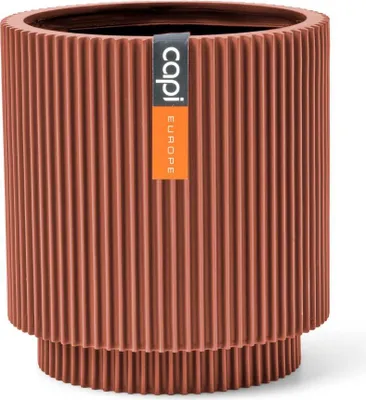 A close-up studio shot of a ribbed planter pot.