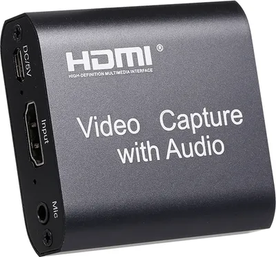 A black video capture device with HDMI input and audio ports.