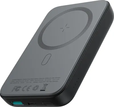 A gray and black power bank with a wireless charging pad on top, shown from a diagonal angle.
