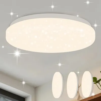 A modern, round LED ceiling light with a starry sky effect, mounted on a white ceiling. Three smaller, oval lights are visible on a shelf below.