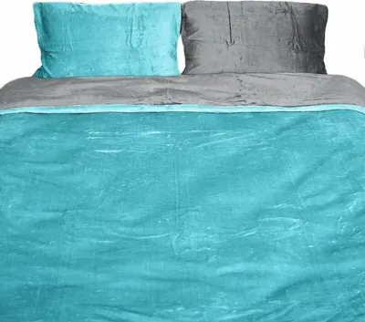A bed with teal and gray bedding.