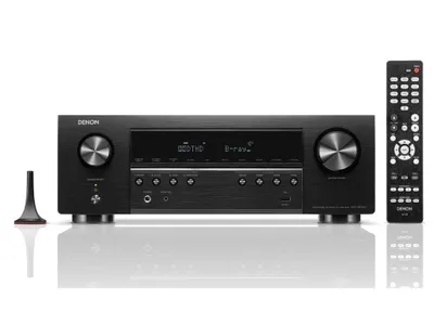 A black Denon AV receiver is shown with its remote control and an antenna.