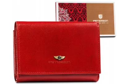 A red leather wallet is displayed with its packaging in the background.