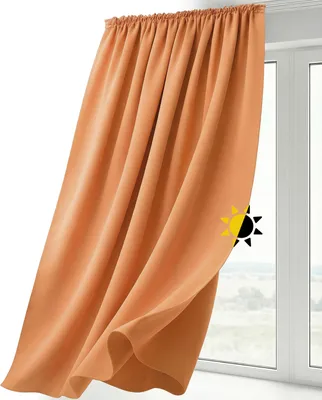 A close-up of an orange curtain hanging in front of a window.