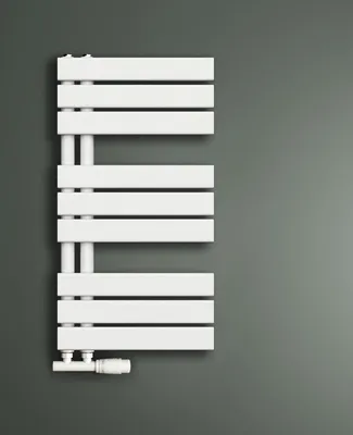 A white towel radiator mounted on a gray wall.