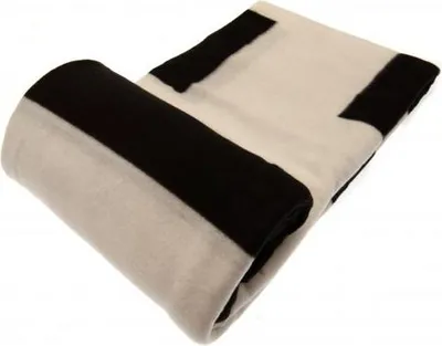 A rolled-up blanket with black and white stripes.