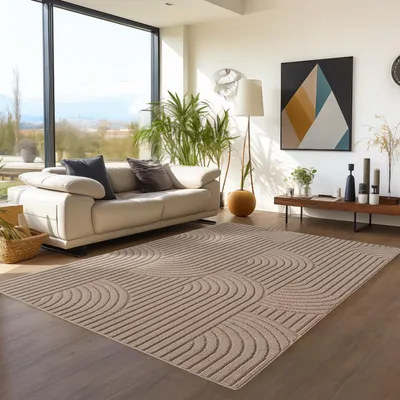 A modern living room with a large window, sofa, plants, and a rug.