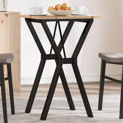 A small square table with a wooden top and a black metal base, set in a room with two stools and a wooden cabinet.