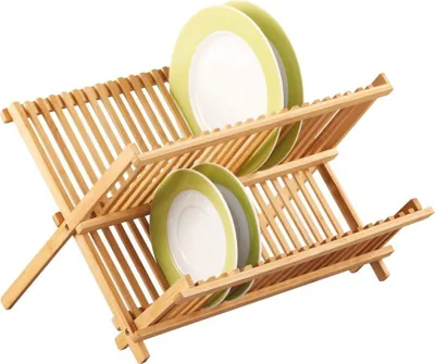 A two-tiered bamboo dish rack holding several plates.