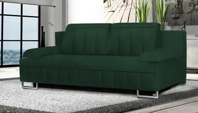 A dark green sofa is shown in a well-lit room with a large window in the background.
