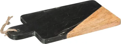 A cutting board with a black marble top half and a natural wood bottom half, with a rope handle.