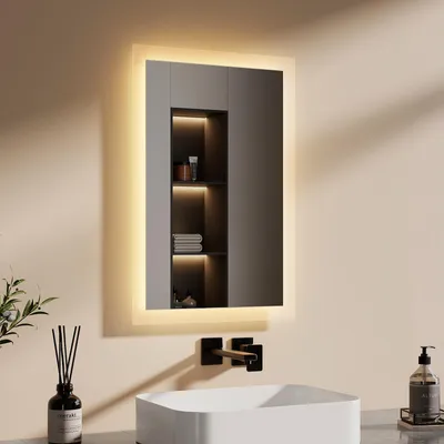 A modern bathroom vanity with a lit mirror, sink, and faucet.
