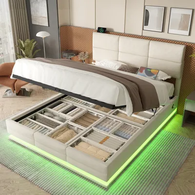 A bed with its storage compartments open, showcasing organized items and illuminated by LED lights.