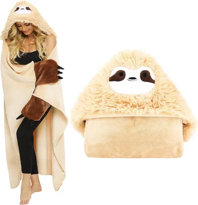 A woman wearing a sloth-themed hooded blanket and a separate sloth-themed pillow.