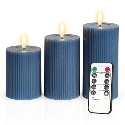 Three blue LED candles of varying heights are arranged with a remote control in front of the largest candle.