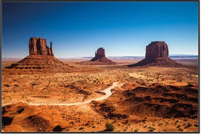 Produktbild von Wallario Wandbild Monument Valley unter blauem Himmel, Größe: 61 x 91,50 cm, Poster mit schwarzem Aluminiumrahmen