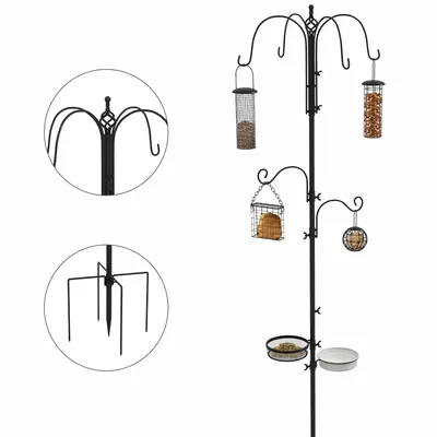 A black metal bird feeding station with multiple feeders and dishes.