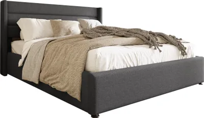 A bed with bedding and a throw blanket, presented against a white background.