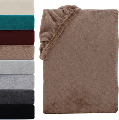 A stack of folded blankets in various colors next to a folded blanket in nougat brown.