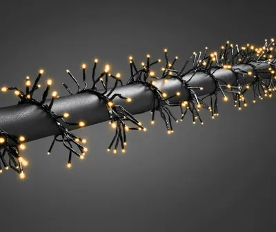 Imagen del producto de Cadena de luces LED micro tipo "arbusto" de Konstsmide, con múltiples funciones, temporizador y regulador de intensidad seleccionables, que reacciona a la música, controlada mediante aplicación (Android e IOS), con 960 diodos ámbar, transformador exterior de 36V y cable negro.- 6563-870