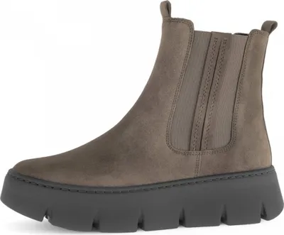 A side view of a single brown Chelsea boot with a thick gray sole, set against a white background.