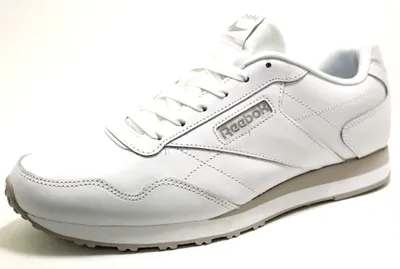 A white Reebok athletic shoe is shown against a white background.