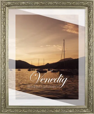 A framed picture of a harbor with sailboats at sunset.