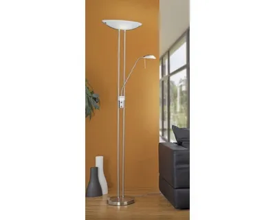 A floor lamp with two lights stands in a room with an orange wall and a window in the background.