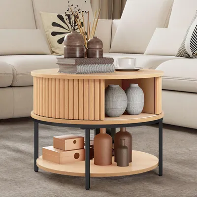 A round coffee table with storage is placed in a living room setting next to a sofa.