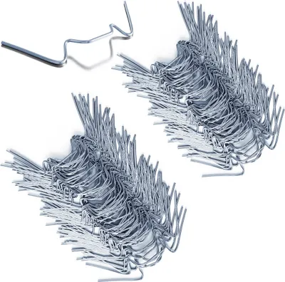 Two piles of metal greenhouse clips on a white background.