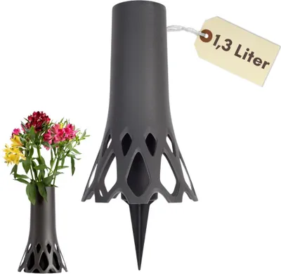 A dark gray vase with a spike for insertion into the ground, shown with a small bouquet of flowers. A second, smaller vase is shown to the left. A tag with text is attached to the larger vase.