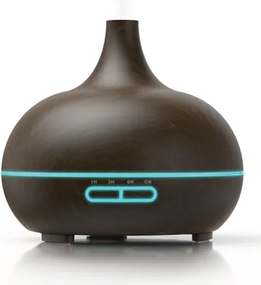 A dark brown aroma diffuser with a wood grain finish, emitting a visible mist from the top. It has a blue LED light strip around its base with illuminated buttons.
