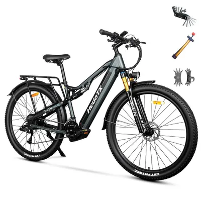 A full-shot image of a gray electric bicycle with black tires and gold suspension forks, presented on a white background. Accessories like a multi-tool, pump, and tire levers are shown in the upper right corner.