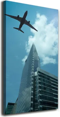 Produktbild von Tulup Leinwandbild® - 70x140cm - Wandkunst - Drucke auf Leinwand - Leinwanddruck - Wohnzimmer Wanddekoration XXL - Wohnung Deko Kunstdrucke - Fahrzeuge - Blau - Flugzeug über der Stadt