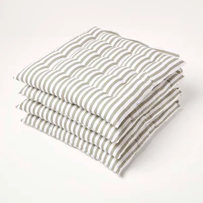 A stack of four striped seat cushions on a white background.