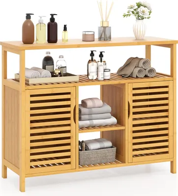 A wooden bathroom cabinet with shelves and doors, filled with towels and toiletries.