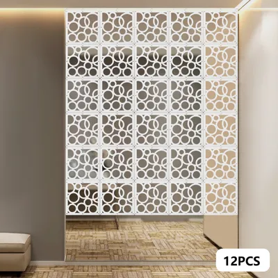 A room divider made of white, square panels with circular cutouts, installed in a room.