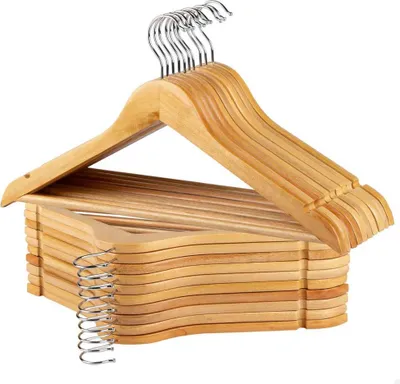 A stack of wooden hangers with metal hooks.
