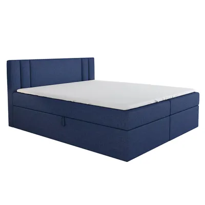 A blue boxspring bed with a white mattress and a white sheet.