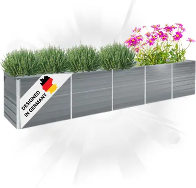 A long, gray planter box filled with green plants and pink flowers, with a "Designed in Germany" label on the side.