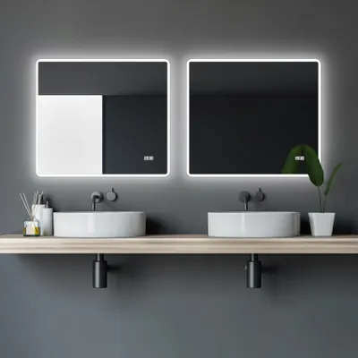 A modern bathroom vanity with two sinks and illuminated mirrors.