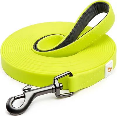 A coiled yellow dog leash with a black handle and a silver metal clasp, presented on a white background.