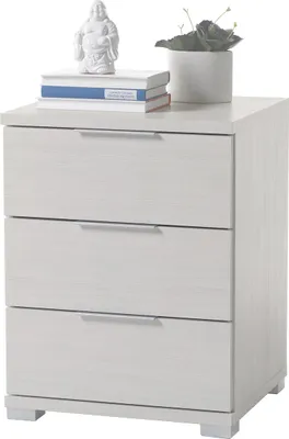 A white wooden nightstand with three drawers, a Buddha statue and books on top.