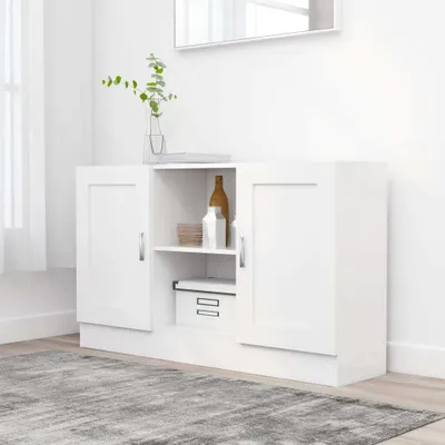 A white sideboard with two doors on the sides and open shelves in the middle, displayed in a room with a rug and a window.