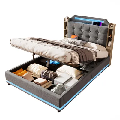 A bed with its storage compartment open, revealing stored items. The bed has a tufted headboard with LED lighting.