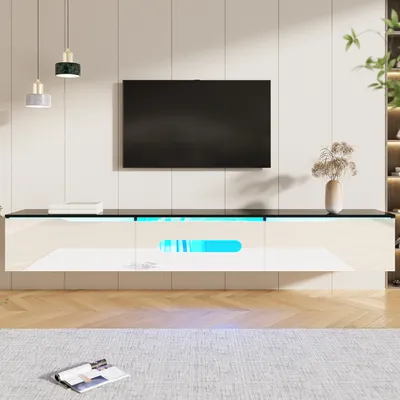 A modern living room setup featuring a wall-mounted TV and a sleek, white TV stand with LED lighting.