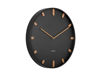 A black wall clock with wooden hour markers, shown from a side angle against a white background.