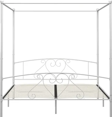 A white metal canopy bed frame with a decorative headboard and a slatted base.