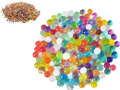 A pile of colorful gel beads and a smaller pile of tiny beads.