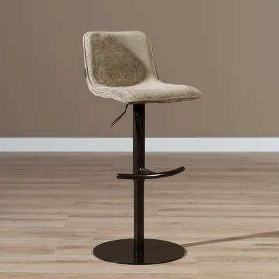 A bar stool is shown in a room with a brown wall and wooden floor.